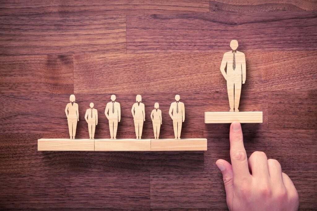Wooden figures showing leadership hierarchy